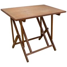 a wooden folding table with two legs on the top and one leg up against it