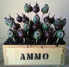 an arrangement of chocolate covered apples in a wooden box with the word amo on it