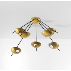 a chandelier with five brass bowls hanging from it's arms and four black rods