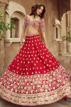 Red embroidered lehenga with floral embroidery in cutdana, pearl and tikki and attached cancan. Paired with a padded embroidered blouse, a red jall work dupatta and another red dupatta with a delicate border.
Components: 4
Pattern: Embroidered
Type Of Work: Cutdana, Pearl, Tikki
Neckline: Leaf
Sleeve Type: Elbow
Fabric: Silk, Organza
Color: Red
Other Details: 
Attached lining
Padded blouse
Approx. product weight: 5 kgs
Lehenga length: 44 inches
Occasion: Bride, Wedding - Aza Fashions Red Cutdana Lehenga For Reception, Red Floor-length Sets For Reception, Designer Red Lehenga For Navratri, Red Floor-length Lehenga With Cutdana, Red Semi-stitched Traditional Wear For Reception, Red Dola Silk Choli For Traditional Ceremonies, Red Lehenga With Pallu For Reception, Festive Red Lehenga For Reception, Red Embroidered Dola Silk Gown