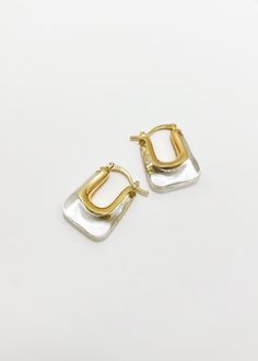 Our classic Christy earrings feature a rectangle shape and transparent gold finish. Perfect for everyday wear, these earrings are both stylish and sophisticated. - Hypoallergenic - 14K Gold Plated over Sterling Silver - Weight: 12 grams Shipping: Ready to Ship Elegant White Huggie Earrings For Everyday, Elegant Square Huggie Earrings, Elegant Oblong Earrings, Elegant Yellow Gold Square Huggie Earrings, Elegant Square Yellow Gold Huggie Earrings, Modern Earrings With Rectangular Stone For Gift, Modern Earrings With Rectangular Stone Gift, Gold Square Earrings With Tarnish Resistance, Gold Rectangular Huggie Earrings