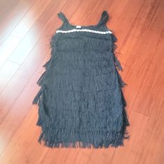 Bring Back The Good Old Days With This Black Flapper Adult Women's Costume. This Beautiful Black 1920's Style Dress Features Fringe Trim . You'll Be The Star Of The Speakeasy! Flapper Dress Black Fringe Sequin Women Adult Small 20s Gatsby Costume. Condition Is New Without Tags. Adult Small Fits A Woman Who Wears Dress Size 4-6 . Waist Is 34-36 Inches Height Is 26-28 Inches Inseam Is 65-68 Inches. Material Is 100% Polyester Black Sleeveless Flapper Dress, Sleeveless Flapper Dress With Beaded Fringe, Flapper Dress Black, Black Art Deco Flapper Dress With Sequins, Black V-neck Flapper Dress For Evening, Vintage Black Flapper Dress With Beaded Fringe, 1920s Fashion Dresses, Gatsby Costume, 1920's Style