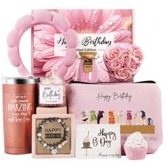 a birthday gift hamper with pink flowers, cupcakes and other items