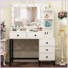 there is a white vanity with drawers and a mirror on the wall next to it