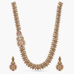 Yahvi Antique Long Necklace Set: Bestselling Indian Jewelry at Tarinika.com Heavy Gold Kundan Long Necklace, Elegant Hand Set Brass Necklace, Elegant Brass Necklace With Hand Set Details, Elegant Brass Necklace With Hand Set, Elegant Hand-set Brass Necklaces, Elegant Heavy Long Necklace, Ornate Jeweled Necklaces For Festivals, Heavy Gold Long Bridal Necklace, Gold Long Bridal Necklace