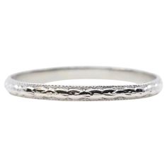 A hand engraved original Art Deco period wedding band in platinum. This ring features beautiful carved flowers throughout and a border of miligrain beading. In excellent condition, this ring is a size 8 US and measures 2mm across. Ring tests as platinum. Classic Platinum Rings With Decorative Band, Heirloom Etched Wedding Bands, Heirloom Round Bands With Milgrain Detail, Classic Platinum Jewelry With Decorative Band, Classic Engraved Ring With Intricate Design, Timeless Engraved Ring With Decorative Band, Heirloom Engraved Ring With Diamond Cut In Round Band, Heirloom Engraved Ring With Diamond Cut For Ceremonial Occasions, Elegant Carved White Gold Rings