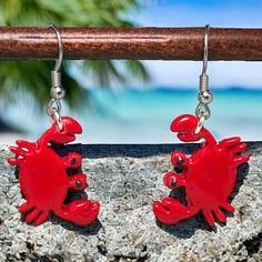 Add some fun and flair to your summer wardrobe with these handcrafted red crab polymer clay dangle earrings finished in resin. These unique earrings are the perfect accessory for adding a pop of color and whimsy to any outfit. Featuring adorable 1 inch red crabs dangling from stainless steel earwires, these earrings are lightweight and comfortable to wear all day long. The vibrant red color of the crabs is sure to stand out and make a statement wherever you go. Don't miss out on these perfect su Red Resin Novelty Earrings, Novelty Red Resin Jewelry, Red Resin Novelty Jewelry, Nickel-free Red Earrings For The Beach, Beach Dangle Jewelry In Polymer Clay, Red Polymer Clay Dangle Jewelry, Clay Crab, Crab Earrings, Red Crab