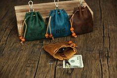 three purses with the name evan on them and some money in front of them