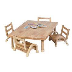 a wooden table with two chairs and a magazine on the top one chair is empty