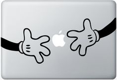 an apple laptop with two hands holding on to each other's strings and the same sticker