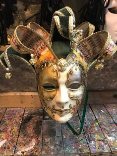 Original hand-painted Venetian mask embellished with gold leaf, decoration with stucco, acrylic colors and precious fabrics. -Material/Resin Made in Italy hypoallergenic and anatoxical -Dimensions/40x37 unisex -History of the mask / the Jester or joker is a mask that appears in Venice in 1970 year in which the Venetian Carnival returns to its former glory after being interrupted during the Napoleonic domination (1700') and Austro-Hungarian (1800'). Formerly a symbol of transgression and enjoyabl Jester Mask, Carnival Parties, Mask Carnival, The Jester, Venice Mask, Venetian Masquerade Masks, Ceramic Mask, Venetian Carnival, Carnival Mask