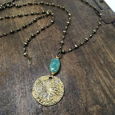 "Antiqued brass Burmese \"Harvest\" coin representing abundance paired with a tuquoise colored ceramic bead.  Hangs on a fully adjustable brass chain that clasps anywhere along the chain for full flexibility. The chain can also be worn alone as a single chain, is long enough to be worn doubled up or wrapped as a bracelet.  Total length is 40\"" Nickel Free Brass Coin Pendant Necklace, Bohemian Jewelry With Adjustable Chain And Medallion, Bohemian Brass Coin Necklace As Gift, Bohemian Medallion Coin Necklace Nickel Free, Bohemian Jewelry With Medallion And Adjustable Chain, Turquoise Brass Jewelry For Festivals, One Of A Kind Brass Medallion Jewelry, Bohemian Style Medallion Coin Necklace, Bohemian Medallion Necklace With Coin Pendant In Brass