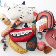 an assortment of stuffed toys including toothbrushes and other items on a white surface