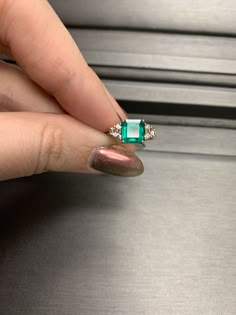 Metal: 14 karat yellow gold Main Stone: Natural Fine Emerald 1.80 carat Square Emerald Faceted Origin, Columbia Side Stones: 6 Natural Diamonds .25 carat GH/VS Size: 5.5, Can be Resized by most jewelers with a LASER Welder only. (contact your local jeweler) Vintage: 90s Great Mother's Day gift idea for the mom who loves jewelry and has it all Columbia Emerald Ring, Luxury Asscher-cut Jewelry With Accent Stones, Luxury Asscher Cut Jewelry With Accent Stones, Luxury Emerald Jewelry With Accent Stones, Dazzling Emerald Cut Jewelry With Accent Stones, Emerald Cut Jewelry With Accent Stones, Columbian Emerald Ring, Dazzling Diamond Emerald Ring With Accent Stones, Dazzling Emerald Ring With Diamond Accent Stones