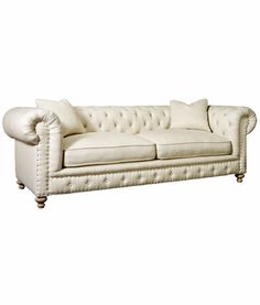 a white couch sitting on top of a wooden floor