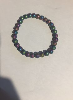 "Colorful Rainbow Hematite Gemstone Stretch Beaded Bracelet 8 mm Matte or Shiny and 7.5\" or 8\" They stretch with the elastic. Rainbow Hematite Hematite is an iron oxide mineral which occurs in most metamorphic and sedimentary rocks. Hematite often occurs intermixed with Quartz. ... Hematite intermixed with Goethite is also known as Rainbow Hematite and is wonderfully iridescent. Hematite has very strong grounding energy; you can feel that just by holding the stone in your hand. It also has a c Multicolor Adjustable Pearl Bracelet With 8mm Beads, Adjustable Multicolor Pearl Bracelet With 8mm Beads, Adjustable Hematite Crystal Bracelet With Round Beads, Beaded Hematite Bracelets, Multicolor Pearl Bracelet With 8mm Round Beads, Iridescent 8mm Round Bead Jewelry, Hematite Stretch Bracelet With 8mm Beads, 8mm Hematite Beads Jewelry, Hematite Bracelet With 8mm Beads