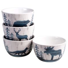 three bowls with moose designs on them sitting next to each other in front of a white background