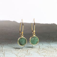 "Raw Emerald Gold Drop Earrings - Minimalist Geometric Green Emerald Circle Drop Earrings - Gold Jewelry gifts for her, mom, wife, daughter NECKLACE SOLD SEPARATELY Stone: Genuine Raw Emerald Please note due to nature of our genuine stones no two are alike and the ones you will receive will vary slightly from the ones pictured in the photos. Bezel: Vermeil Gold Ear-wire: 14k Gold Filled Total length of earring: 35mm Circle Gemstone: 12mm diameter About \"Gold Filled Jewelry\": Also called rolled Minimalist Round Earrings For Her, Minimalist Single Green Earring, Minimalist Round Earrings As Gift For Her, Modern Round Earrings For Gifts, Minimalist Round Threader Earrings, Minimalist Yellow Gold May Birthstone Earrings, Dainty Linear Earrings As Gift, Everyday Green Lever Back Earrings, Minimalist Yellow Gold Earrings For May Birthstone