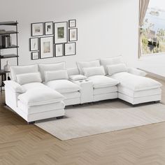 a large white sectional sofa sitting on top of a hard wood floor