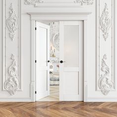 an empty room with wooden floors and white walls, decorated with ornate moldings on the wall