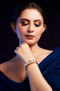 Level up your style with this exquisite Victorian Polki bangle, ideal for any occasion. Their intricate design, accentuated by delicate cubic zirconia edges, enhances the beauty of any ensemble, adding a touch of elegance and charm to your look. Finish: 22KT Gold Plating Material: Silver, Copper Alloy, Polki, CZ Color: Gold Size: One Size Closure Type: Screw Box Contains: 1 Bangle Wedding Jeweled Bangle, Elegant Crystal Bangle As A Gift, Formal Diamond Bangle Bracelet With Sparkling Stones, Elegant Silver Cuff Bracelet For Festive Season, Festive Silver Elegant Cuff Bracelet, Festive Elegant Silver Cuff Bracelet, Glamorous Diamond Bangle Bracelet, Elegant Diamond Bracelet With Jewels, Elegant Bangle Cuff Bracelet With Sparkling Stones