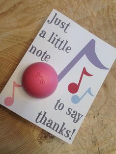 a pink ball sitting on top of a piece of paper next to a note that says just a little note to say thanks