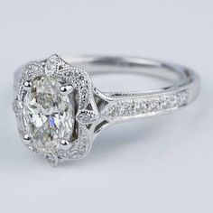 an oval cut diamond ring with pave set shoulders