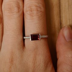 It is a (garnet) ring. The main stone is 5 mm*7 mm emerald cut).weight about 1.30 carats. The basic metal is sterling silver and plated with rhodium/14k white gold/14k rose gold/14k yellow gold You can also go to my shop Home for more elegant rings: https://www.etsy.com/shop/godjewelry?ref=hdr_shop_menu Customization is always welcome and please feel free to contact with me if you have any design ideas! Sterling Silver Emerald-cut Birthstone Ring For Anniversary, Rectangular Garnet Rings In Elegant Style, Elegant Garnet Rings In Rectangular Shape, Sterling Silver Emerald Cut Birthstone Ring For Anniversary, Emerald Cut Sterling Silver Birthstone Ring For Anniversary, Elegant Rectangular Garnet Rings, Emerald Cut Sterling Silver Birthstone Ring In White Gold, Modern Garnet Jewelry For Anniversary, Classic Rectangular Garnet Jewelry