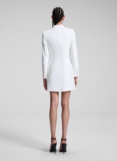 The Juliet Dress is crafted from our signature suiting fabric in bridal white. This mini blazer silhouette features modern twists on classic tuxedo-inspired details, including pointed notch lapels, a faux-wrap waist, flap pockets, and an asymmetrically pleated skirt. Shop Dresses Styling Tip: Pair yours with white or metallic high-heeled sandals for your rehearsal dinner or engagement party. Elegant Fitted Blazer Dress With Pressed Crease, Elegant Blazer Dress With Pressed Crease, White Fitted Dress With Double-breasted Buttons, White Fitted Double-breasted Dresses, Elegant Blazer Dress With Structured Shoulders For Formal Occasions, Elegant Tailored Blazer Dress With Structured Shoulders, Elegant Formal Blazer Dress With Structured Shoulders, Tailored Structured Blazer Dress For Formal Occasions, Classic Mini Length Blazer Dress For Formal Occasions