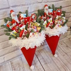 two red cones filled with candy sitting on top of a table