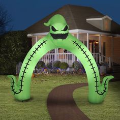 an inflatable halloween arch with a creepy face on the front and back yard