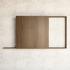 an empty wooden frame hanging on the wall