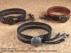 three leather bracelets with metal clasps and beads on them sitting on a table