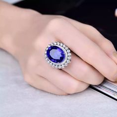 Welcome to Elegant Art Jewelry!  Material: 18k Solid White Gold Stone: Tanzanite Stone Weight: 14.86ct Stone Size: 13mm×17mm Stone Origin: Tanzania Stone Clarity: D Block Gemstone Cut: Oval Cut Side stone: Diamond Weight: 1.10ct Personalization: 9K/14K/24K/GOLD/SILVER/PLATINUM/ROSE-GOLD/WHITE GOLD. (Contact me)  Tanzanite Ring, Tanzanite Cuff Ring, 925 Sterling Silver Ring, Round Shape Ring, Tanzanite Ring, Tanzanite Engagement, Open Design Ring, Tanzanite Oval, Tanzanite Natural, Blue Tanzanite Tanzanite Studs, Ring Luxury, Luxury Ring, Oval Cut Ring, Emerald Ring Gold, Tanzanite Diamond Ring, Tanzanite Diamond, White Gold Engagement Ring, Victorian Rings