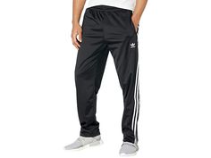 adidas Originals Firebird Track Pants - Men's Workout : Black 2 : The adidas Originals Firebird Track Pants have a '90s-inspired style and feature pintucks on the legs and signature subtle sheen that lends a throwback look. These pants have a regular fit that has a just right feel that isn't too tight or too loose. The elastic waistband with an adjustable drawcord so you get a secure feel every time. Zip close pockets in front let you keep the essentials safe when you're on-the-go. Sports a clas Track Pants Mens, Men's Workout, Mens Adidas, Adidas Outfit, 90s Inspired, Firebird, Pin Tucks, Stripes Design, Mens Fitness