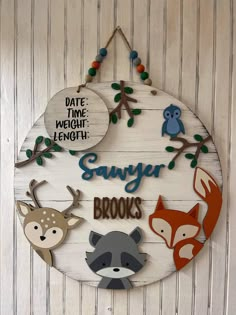 a wooden sign with different types of animals on it