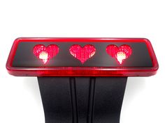 three hearts on the back of a red light