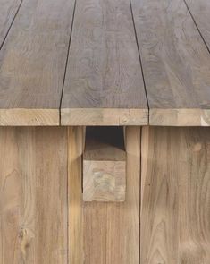 a close up of a wooden table with wood planks on the top and bottom