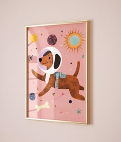 a dog in an astronaut's suit is hanging on the wall next to a pink background