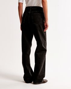 Our new mid rise slouchy jeans in a black wash with a clean hem. This fit features a 9.5” mid rise, is slouchy at the waist and hips, and eases through the thigh into a baggy, full-length leg shape. We recommend buying your true size for a slouchier fit. Size down for a closer fit. This jean is made from our heavyweight rigid denim, a super soft authentic cotton fabric with no stretch. Spring Black Flare Jeans In Rigid Denim, Black Washed Rigid Denim Bottoms, Washed Black Relaxed Fit Mid-rise Jeans, Washed Black Mid-rise Relaxed Fit Jeans, High Rise Straight Fit Black Jeans, Black Flare Jeans For Spring Everyday Wear, Black Rigid Denim Bottoms With Straight Hem, Washed Black Mid-rise Rigid Denim Bottoms, Classic High Waist Washed Black Bottoms