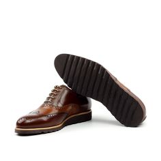 Also known as a wingtip, the Full Brogue is easily identifiable as one of the most classic pairs of men's dress shoes on the market. Featuring a brogue pattern along the sides as well as the toe cap, every man needs a Full Brogue in his shoe closet. Sole units (different available) are Blake stitched to uppers. Upper Materials: Chestnut Brown Box Calf Lining: Caramel Brown Calf Leather Sole: Brown Heeled Rubber Sole Last: Zurigo - Rounded Toe for Traditional English Look YOUR Package Includes Le Brown Brogue Lace-up Shoes With Moc Toe, Classic Brown Wingtip Derby Shoes, Brown Goodyear Welted Oxford Lace-up Shoes, Brown Leather Shoes With Goodyear Welt Construction, Branded Insole Wingtip Oxfords, Brown Wingtip Lace-up Oxford Shoes, Brown Wingtip Dress Shoes With Leather Sole, Brown Goodyear Welted Wingtip Dress Shoes, Brown Cap Toe Oxfords With Brogue Detailing