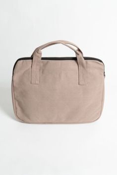 Whether you’re a minimalist who likes to do more with less, or you’re a maximalist tired of digging your laptop out of a jam-packed backpack or bag, our new Laptop Sleeve with handles will help you get a handle on staying organized and on the move. Made with 14-oz organic cotton canvas and padded with organic cotton fiber for padding and softness, our eco-friendly laptop sleeves are made to protect your machine from the jostling, grit, and abrasion of transport in a backpack or tote. Designed to Versatile Laptop Bag With Sleeve Backpack, Versatile Laptop Bag With Sleeve In Standard Backpack Style, Versatile Laptop Backpack With Sleeve, Versatile Laptop Bag With Sleeve For School, Versatile School Laptop Bag With Sleeve, Modern Tote Laptop Bag For School, Practical Bags With Laptop Sleeve For Everyday Use, Modern Laptop Bag With Luggage Sleeve For School, Functional Beige Laptop Bag For Everyday Use