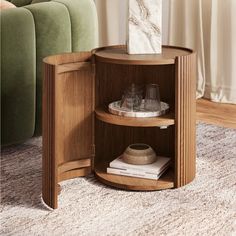 a corner table with a marble vase on top and two glasses in the bottom shelf