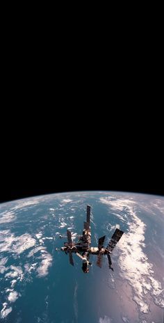 the international space station as seen from the earth's orbit, taken by nasa astronauts