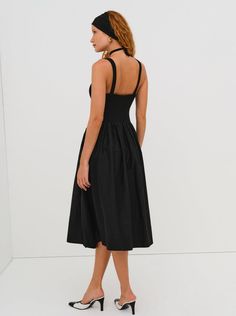 The Billie Midi dress by For Love & Lemons is a timelessly elegant dress that will remain in your wardrobe for years to come! This midi dress has a poplin skirt, a knit bodice, and a poplin rosette. Available in both cream and black. Elegant A-line Midi Dress With Smocked Back, Elegant Midi Dress With Smocked Bodice For Daywear, Knee-length Ruched Dress With Voluminous Skirt, Knee-length Smocked Bodice Evening Midi Dress, Knee-length Smocked Bodice Midi Dress For Evening, Pleated Midi Dress With Voluminous Skirt, Chic Ruched Midi Dress With Voluminous Skirt, Workwear Midi Dress With Smocked Bodice, Chic Midi Dress With Pleated Bodice And Full Skirt