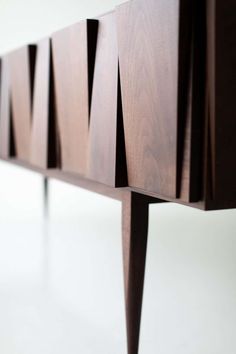 a close up of a wooden bench on a white surface with no people around it