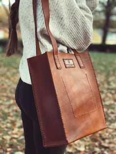 Carefully crafted and stitched by hand in the highlands of Ecuador with full grain leather. The natural imperfections of the leather make each piece unique and full of character. Our Leather Tote bag was designed in small batches to withstand the everyday use, from a walk to the park to a long day at work. Bring all your favorite essentials and get ready for a lifetime of adventures. Measurements: Size 14" (35.56 cm) tall x 12" (30.48 cm) wide x 5" (12.7 cm) deep **Leather is a natural material Rectangular Satchel With Leather Strap For On-the-go, Everyday Bags With Leather Handles And Vegetable Tanned Leather, Leather Shoulder Bag With Waxed Finish For On-the-go, On-the-go Waxed Leather Shoulder Bag, Oiled Leather Rectangular Satchel For Daily Use, Rectangular Oiled Leather Satchel For Daily Use, Daily Use Rectangular Oiled Leather Satchel, Cognac Leather Bag For Everyday Use, Vegetable-tanned Leather Shoulder Bag For Travel