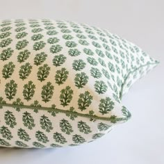 a green and white pillow sitting on top of a table