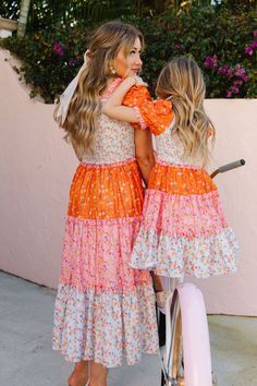 The patchwork dress of your DREAMS now available in bright and bold colors! The Emily Dress features the most fashion forward design, consisting of orange, pink, and stunning floral fabric. She also has an Ivy Favorite smocked bodice, tiered skirt, and dainty puff sleeves. This dress screams, "Ready for Summer" and will be your go-to dress for all your upcoming adventures! Available in size XXS, XS, S, M, L, XL, XXL, 1X, 2X, 3X, 4X, & 5X + kids! Pink Spring Dress With Smocked Bodice, Patchwork Dresses For Garden Party In Spring, Multicolor Smocked Bodice Dress For Spring, Multicolor Smocked Bodice Dress For Garden Party, Playful Spring Dresses With Smocked Bodice, Spring Multicolor Dress With Smocked Bodice, Playful Dresses With Smocked Bodice For Spring, Playful Orange Dress For Spring, Multicolor Floral Patchwork Maxi Dress For Spring