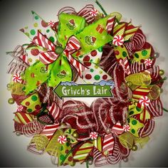 a christmas wreath with candy canes and bows on it that says grin's lait